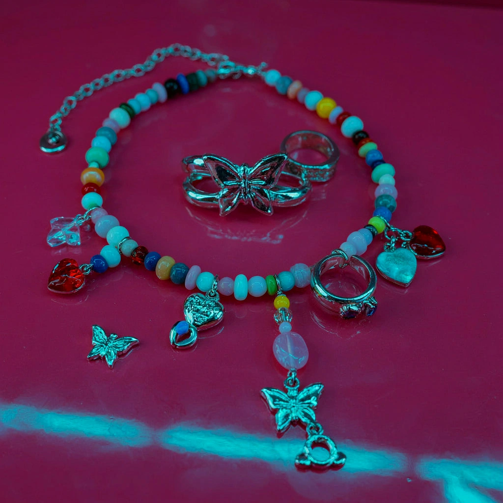Bijoux Y2K : choker papillon, perles colorées et bagues chrome